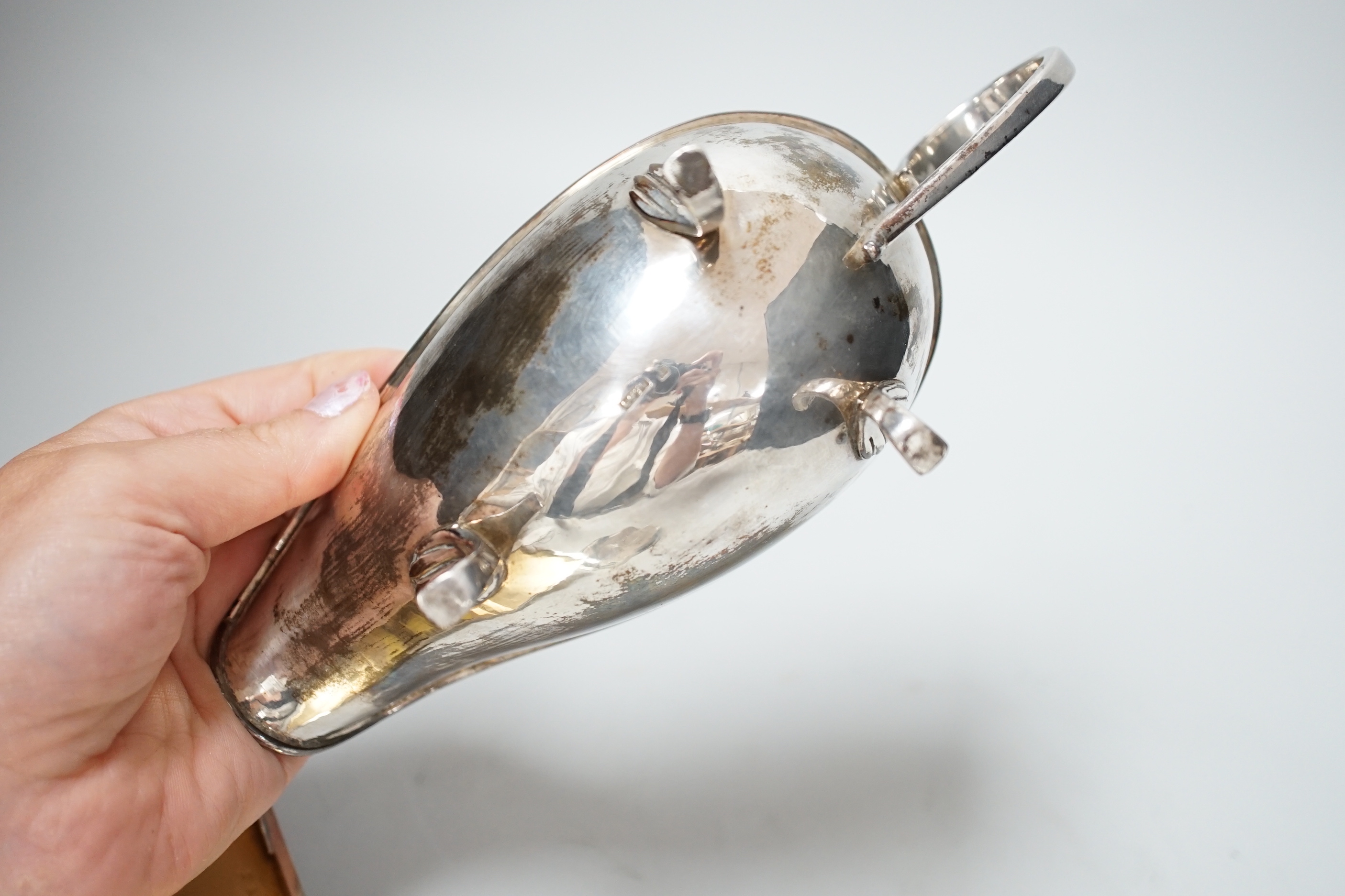 A Victorian silver tureen and cover, with hand holding crown finial and stylised anthemion engravings, makers initials W.T, London 1867, 23cm over handle, 673 grams